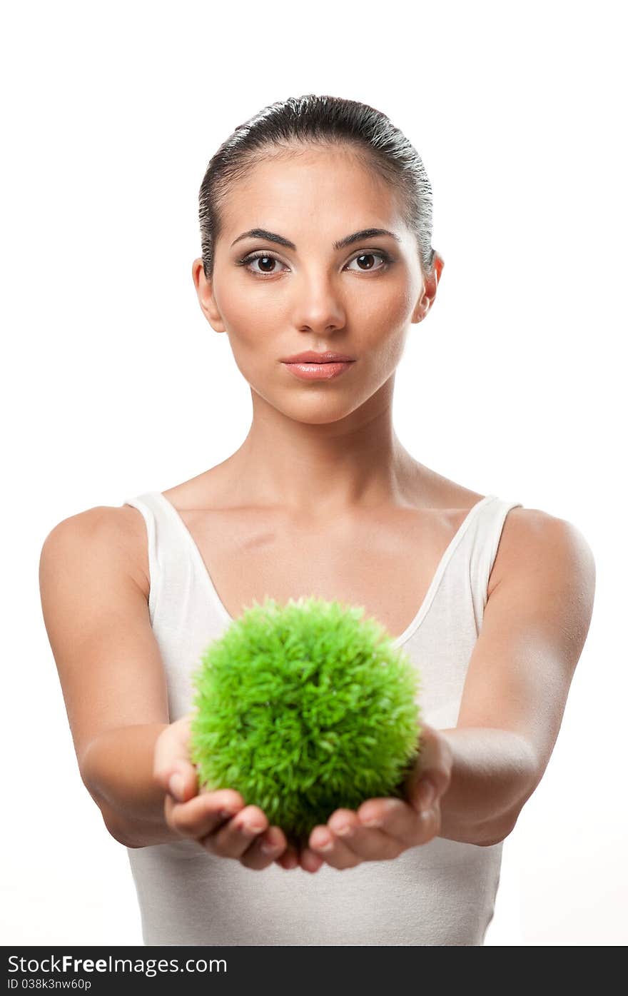 Beautiful young woman holding a sphere of green grass, symbol of care and protection of the natural environment. Beautiful young woman holding a sphere of green grass, symbol of care and protection of the natural environment