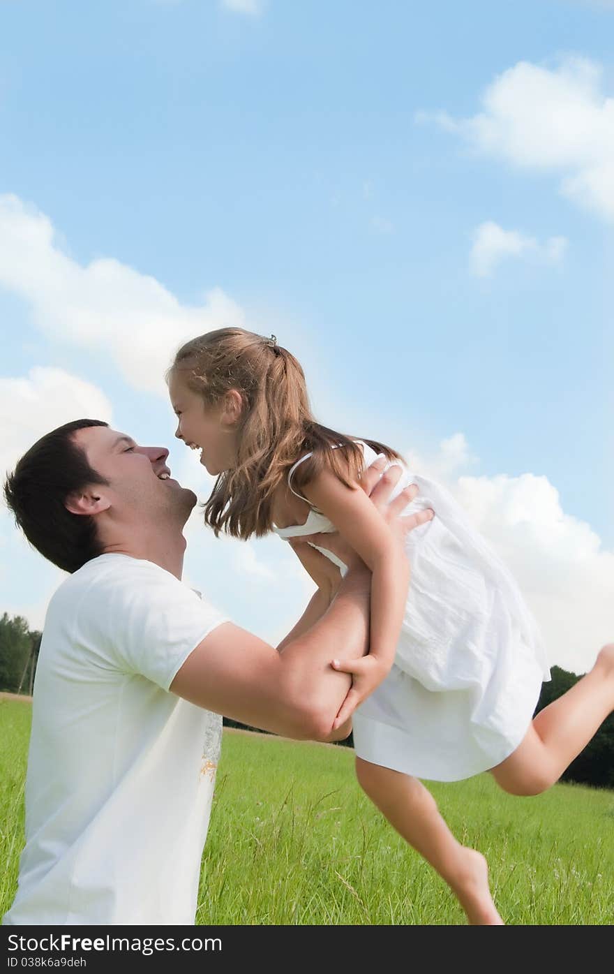 Father and daughter playing in the meadow