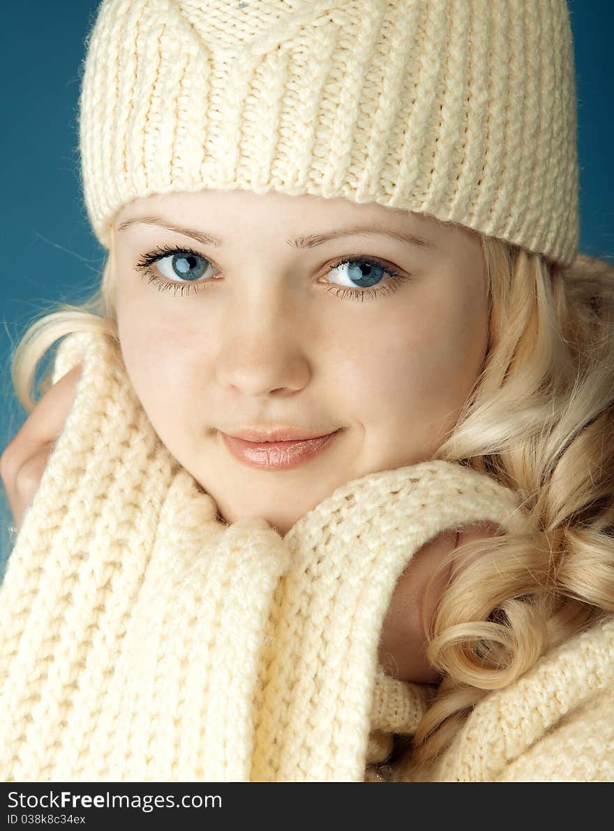 Young girl with scarf in front of the blue background