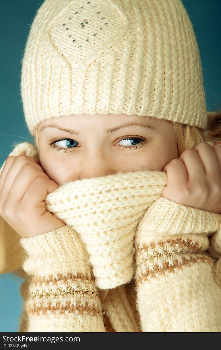 Young girl with scarf in front of the blue background