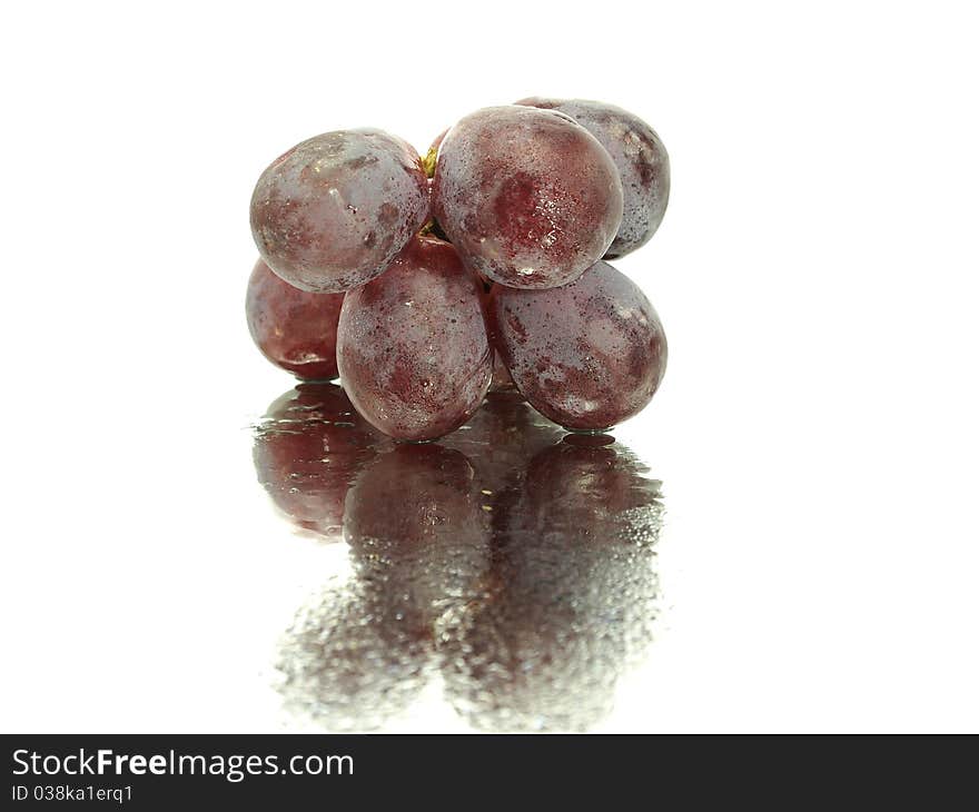 Red grape on a white background with water drops