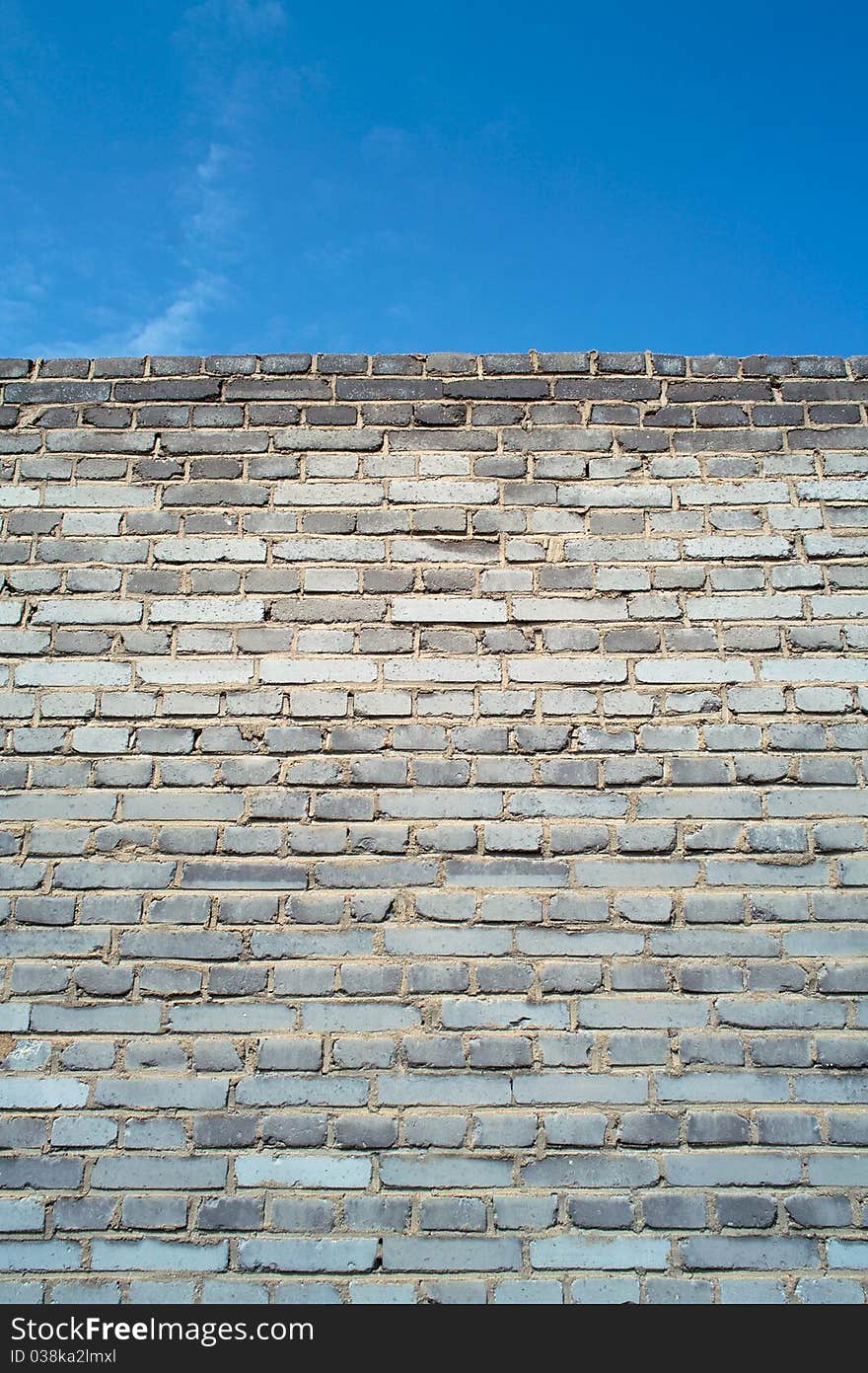 Brick wall under blue sky