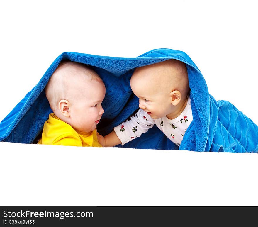 under a big blue towel. Isolated on white background. under a big blue towel. Isolated on white background