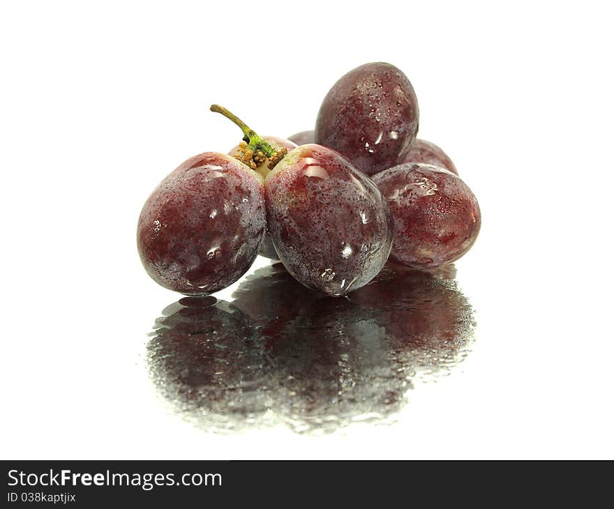 Red grape on a white background with water drops