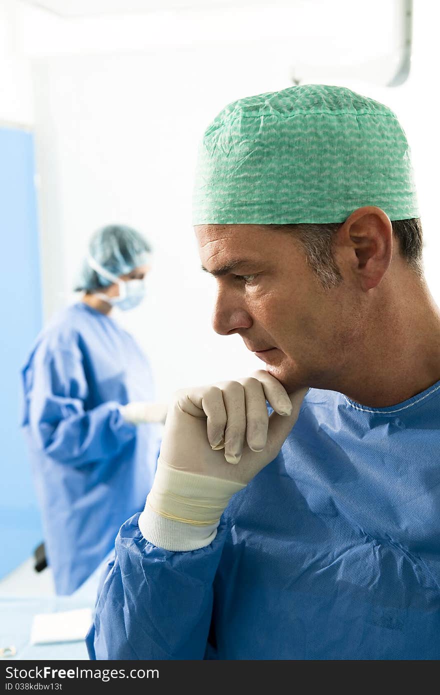 Portrait of a male surgeon, people in tha background. Portrait of a male surgeon, people in tha background