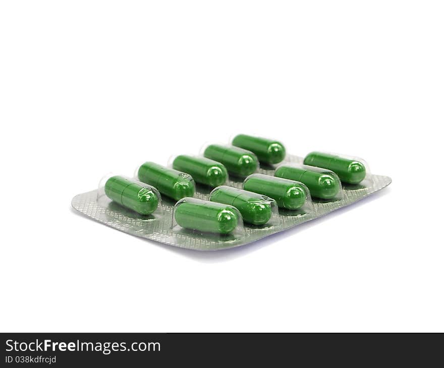 Green pharmaceutical capsules on a white background