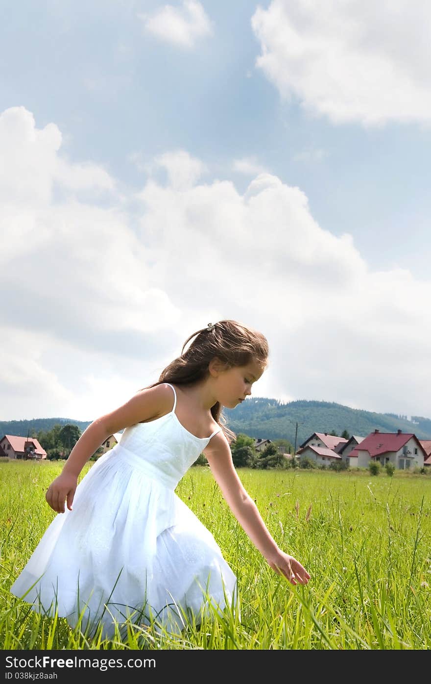 Happy little girl on the meadow