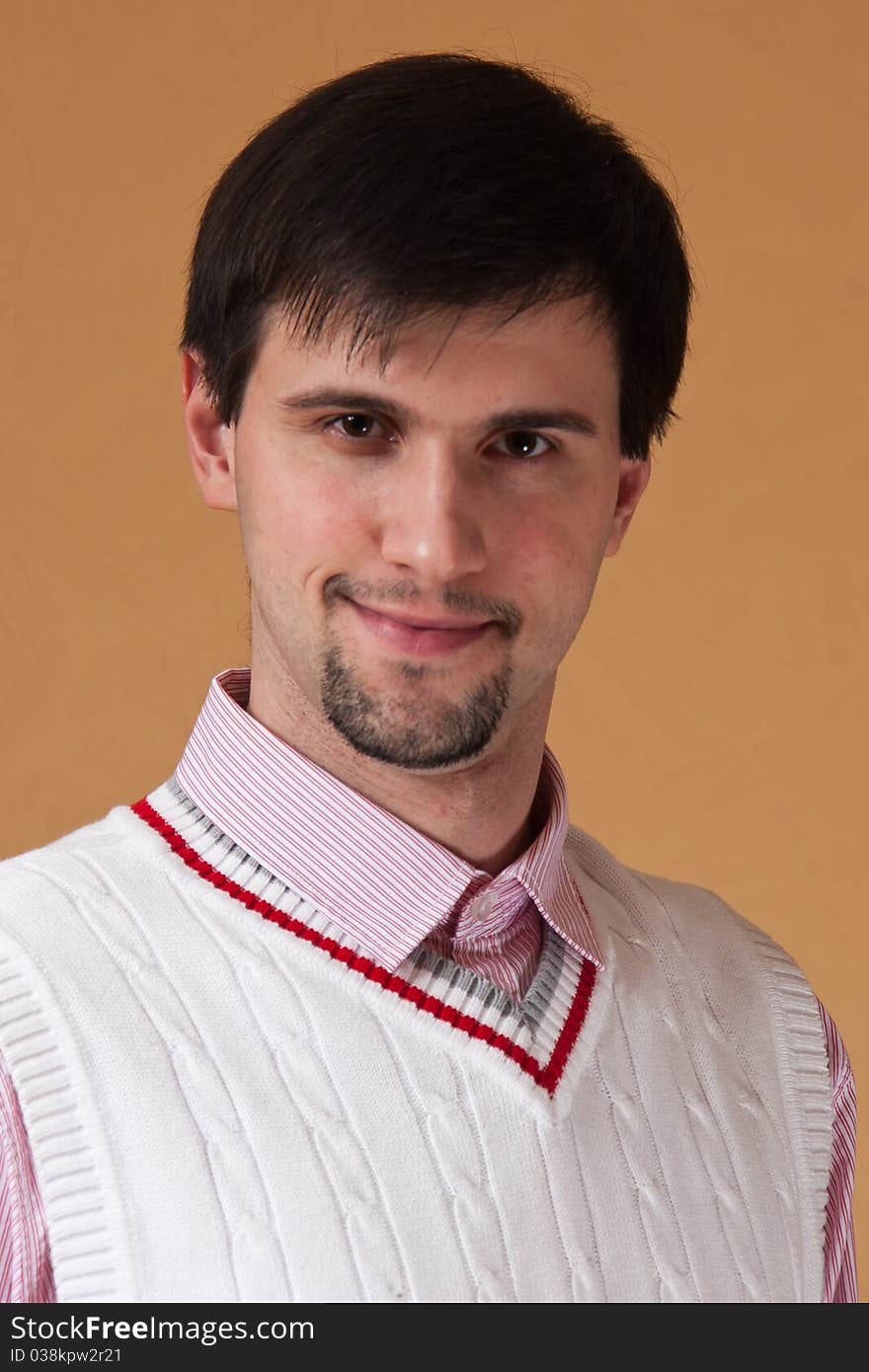 Young man with beard looking at photographer and smiling