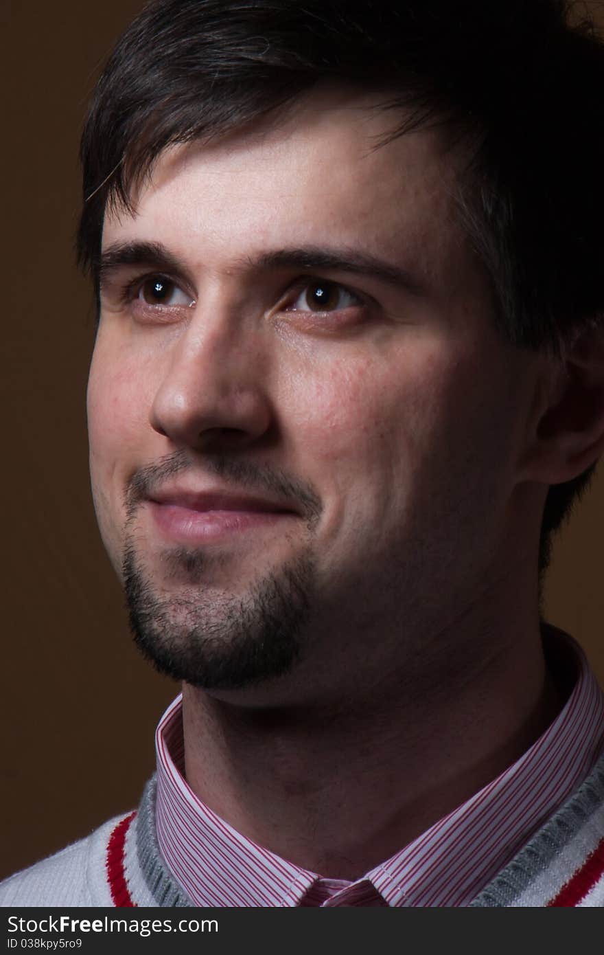 Young man with beard smiling