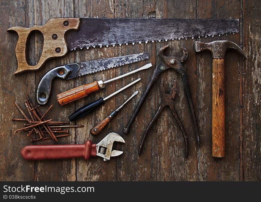 Old tools against wooden wall