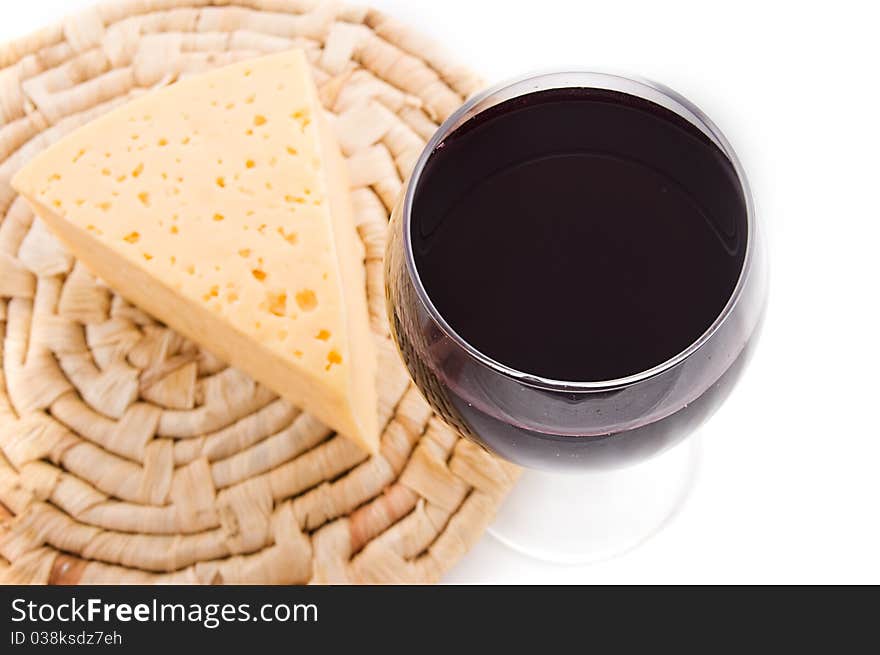 Red wine glass with cheese, upper view