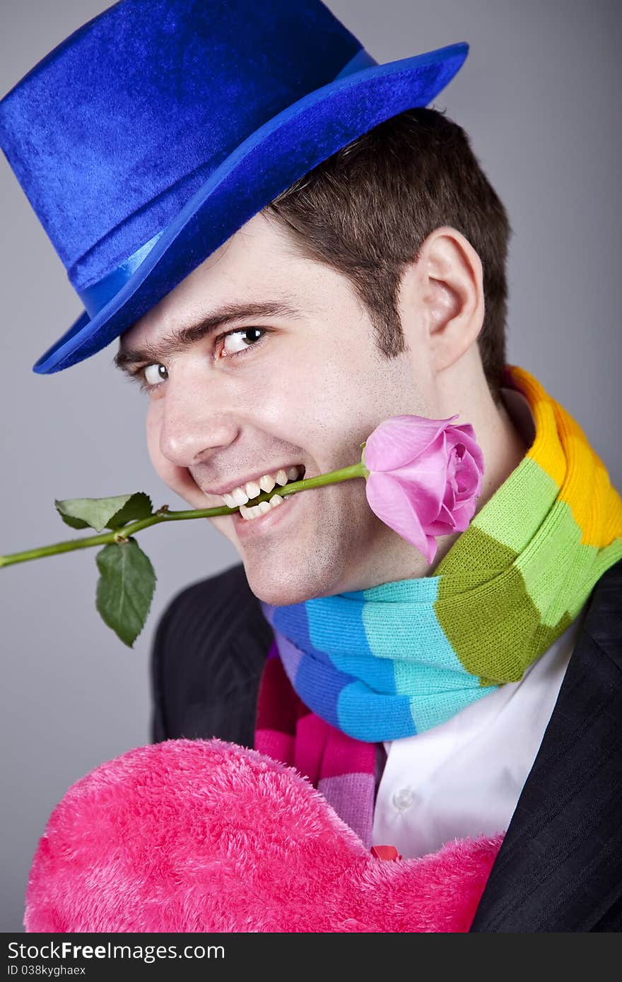 Mysterious men with toy and rose. Studio shot.