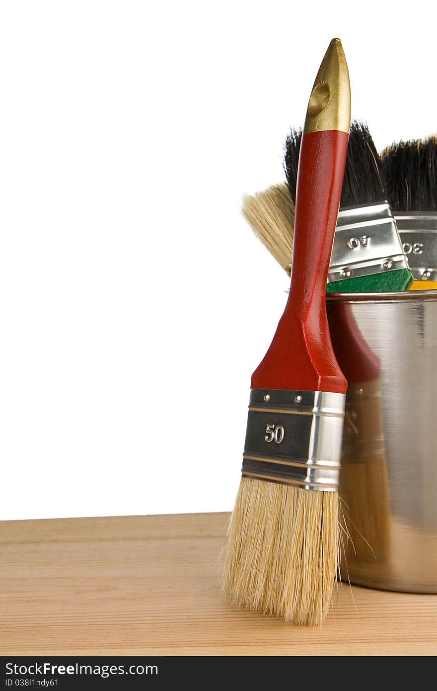 Paint bucket and paintbrush isolated on white