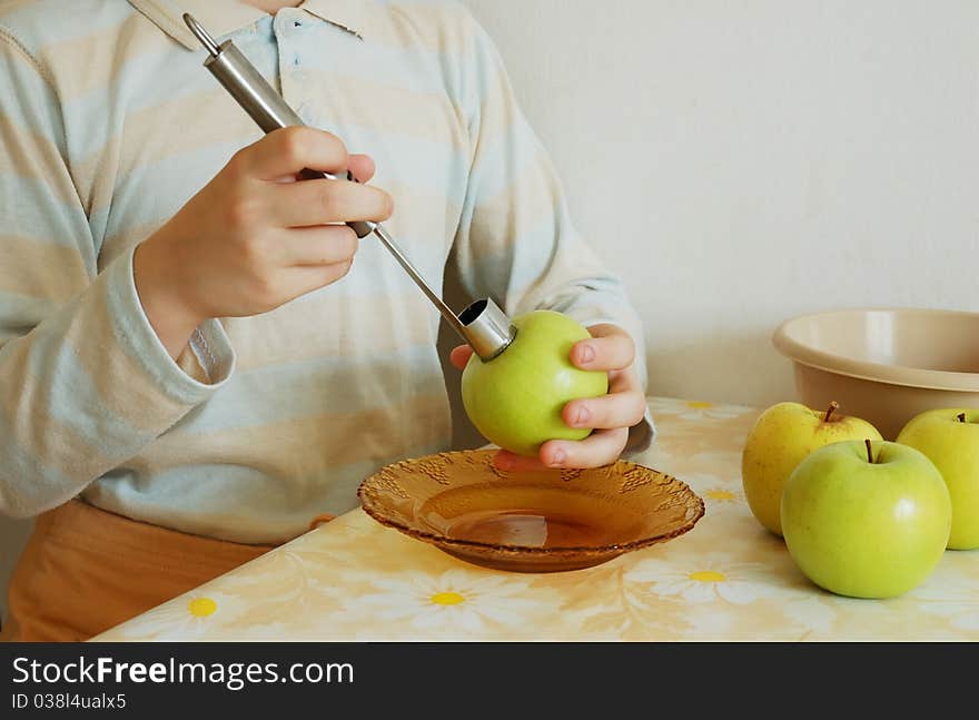 Taking out an apple core. focus on a corer.