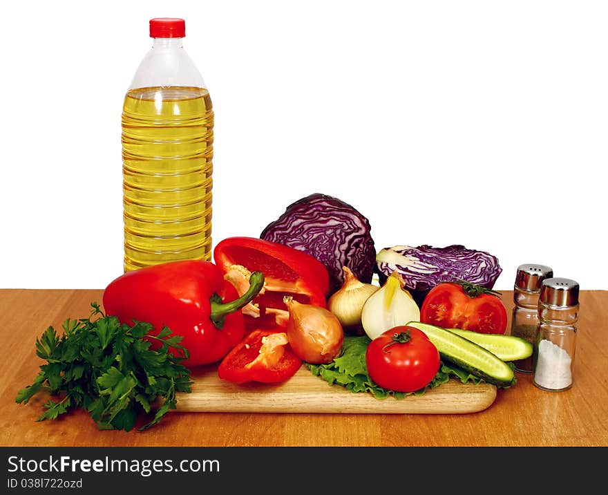 Sunflower seed oil and vegetables for preparation of salad. Sunflower seed oil and vegetables for preparation of salad