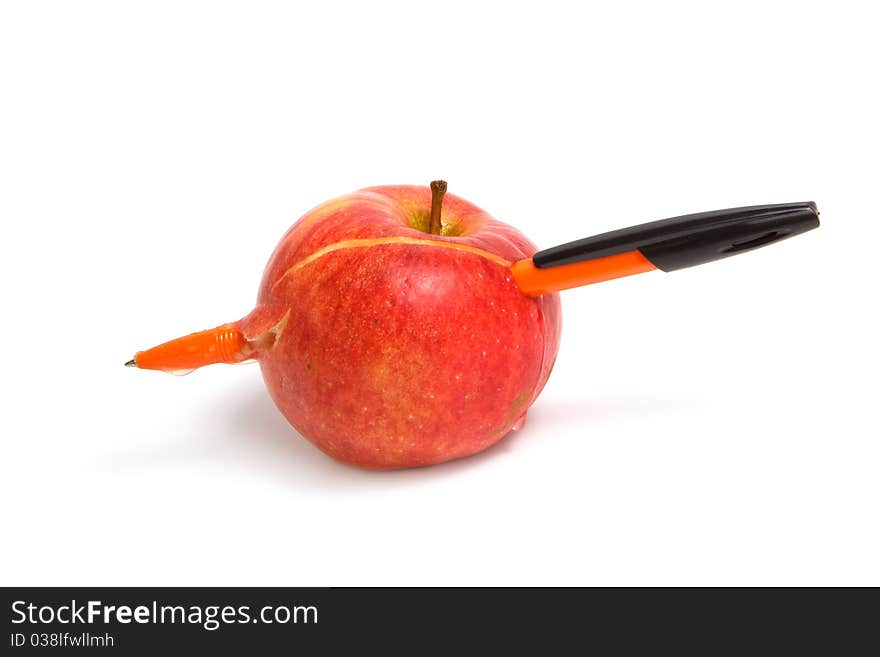 Red apple on a white background pierced by a pen.