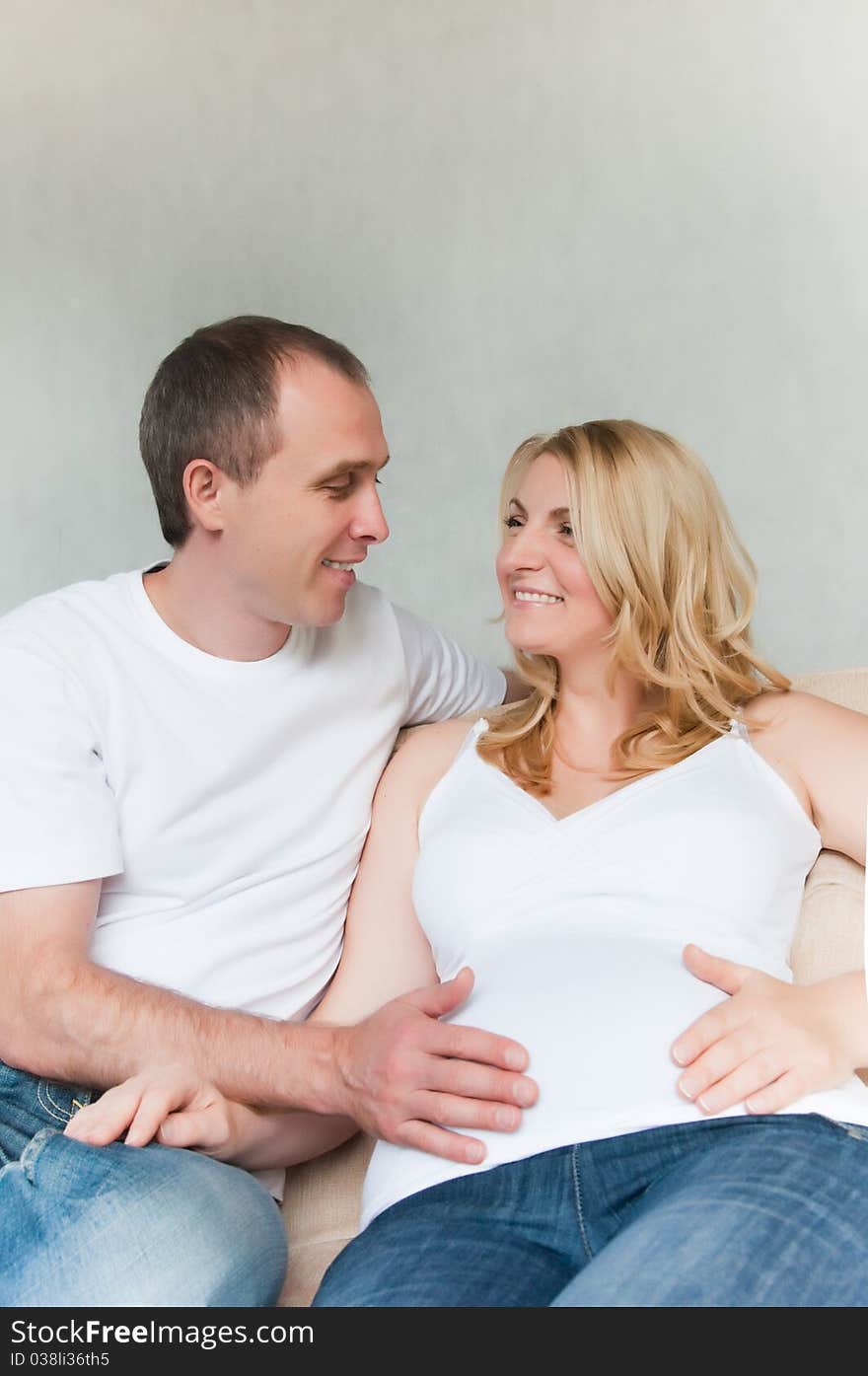 Happy Young Pregnant couple at home. Happy Young Pregnant couple at home