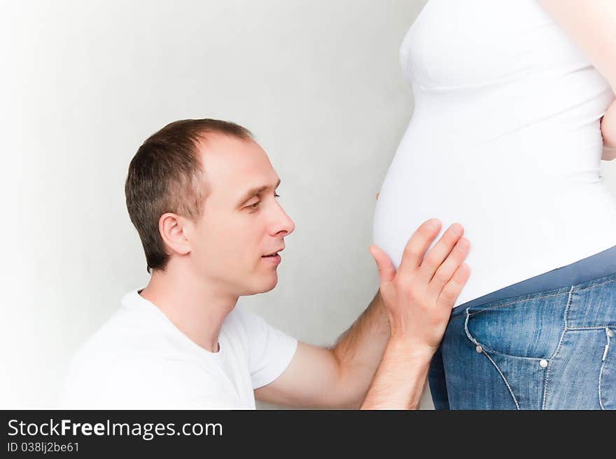 Happy young pregnant couple at home. Happy young pregnant couple at home