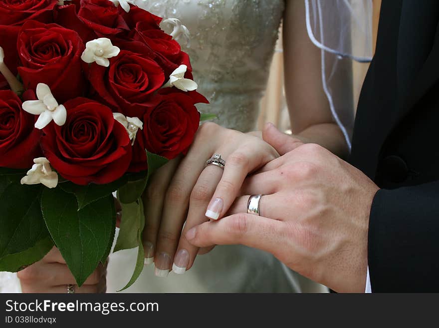 A Bride and Groom showing their rings together. A Bride and Groom showing their rings together.