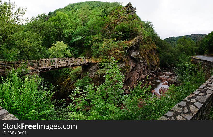 Rickety wooden bridge over a small french mountain stream. Panorama of 6 pictures. Rickety wooden bridge over a small french mountain stream. Panorama of 6 pictures.