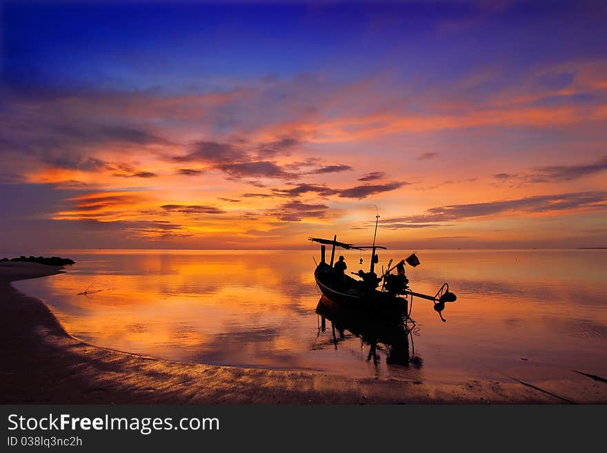 Sunrise and Fishermen boat silhouette in Thailand