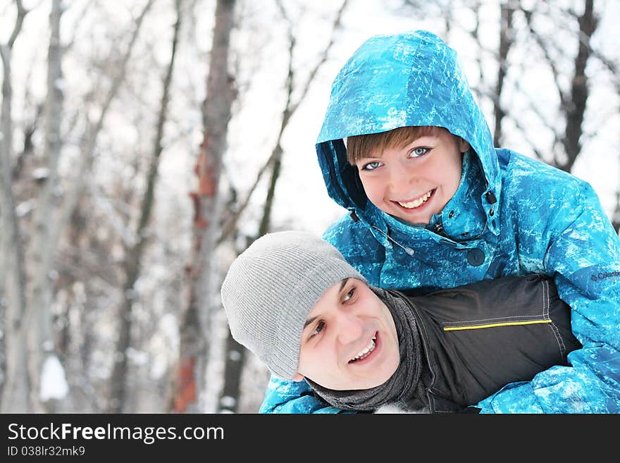 Young playful couple has a fun. Winter