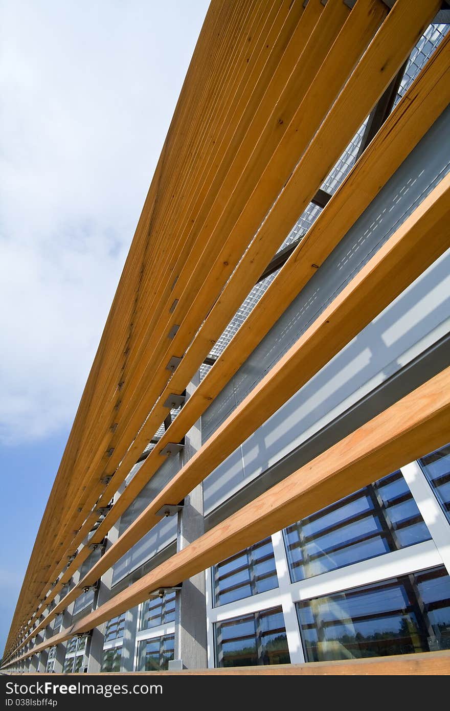 Modern office building under sky with clouds