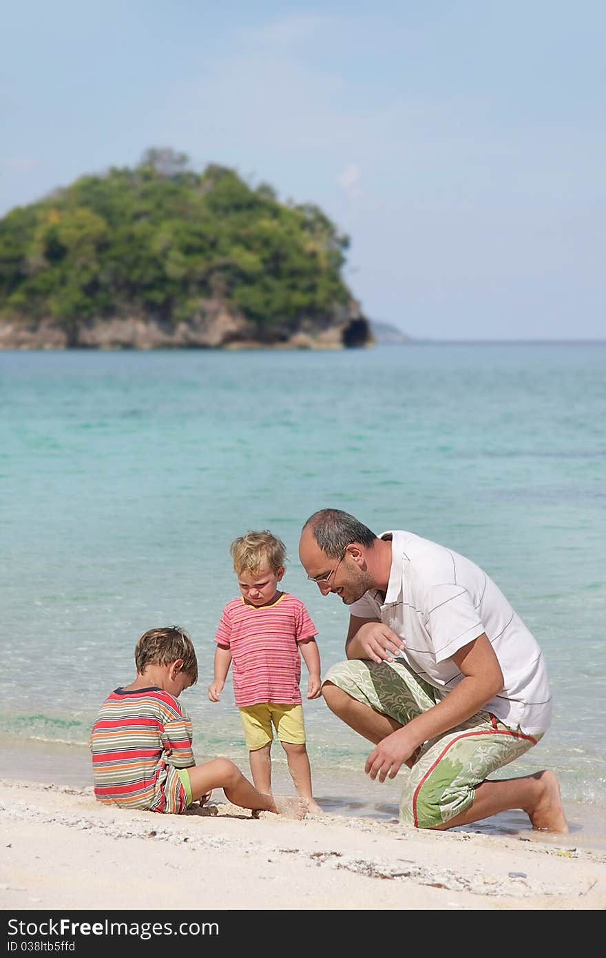 Father and two children on beach