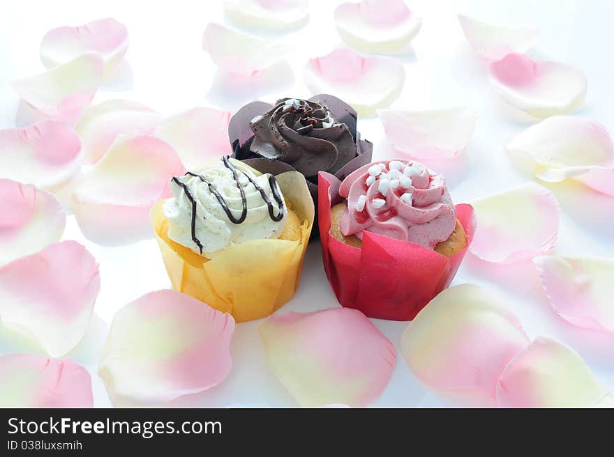 Three colored Muffin on a carpet of rose petals