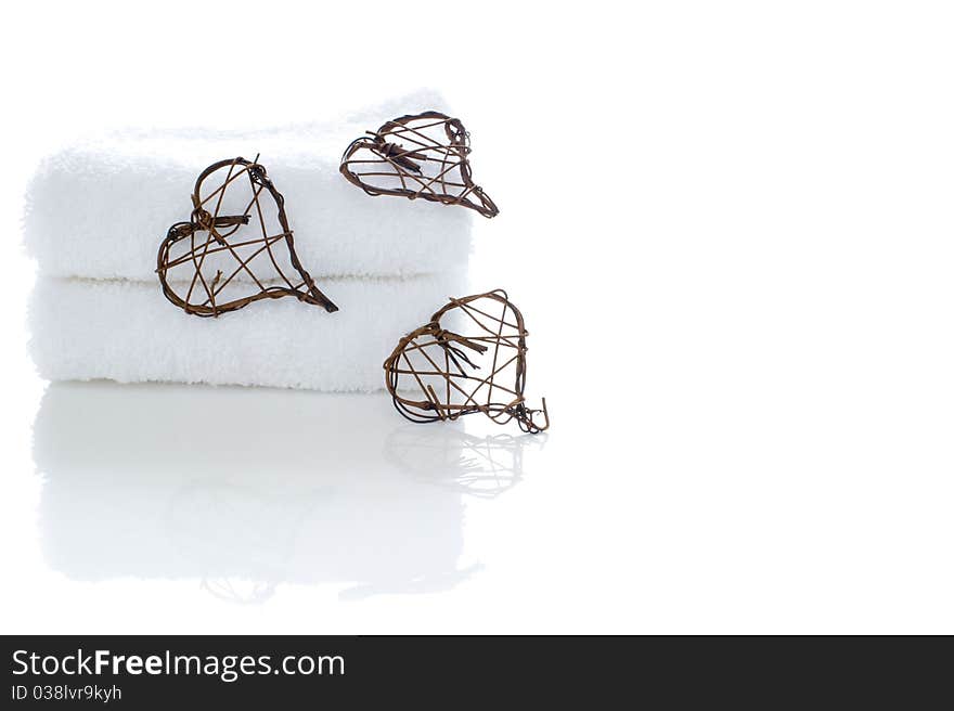 A stack of white towels with woven hearts. A stack of white towels with woven hearts