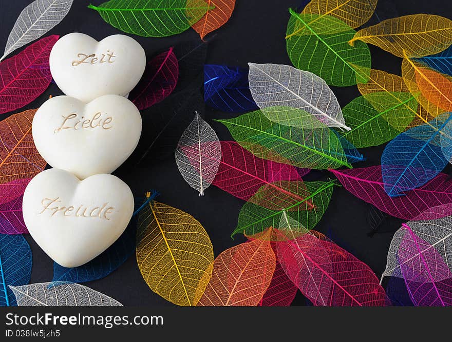 Hearts of stone on the carpet of colorful leaves