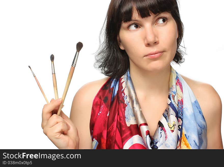 Beautiful girl holding brushes.