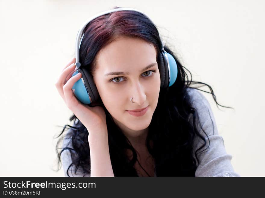 Caucasian dark haired woman with earphones