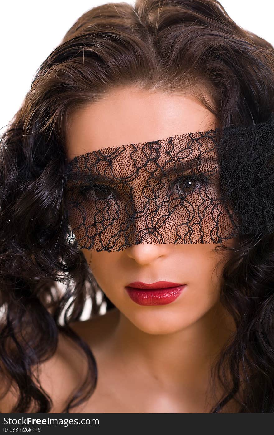 Portrait of young beautiful brunette woman with lace on her eyes