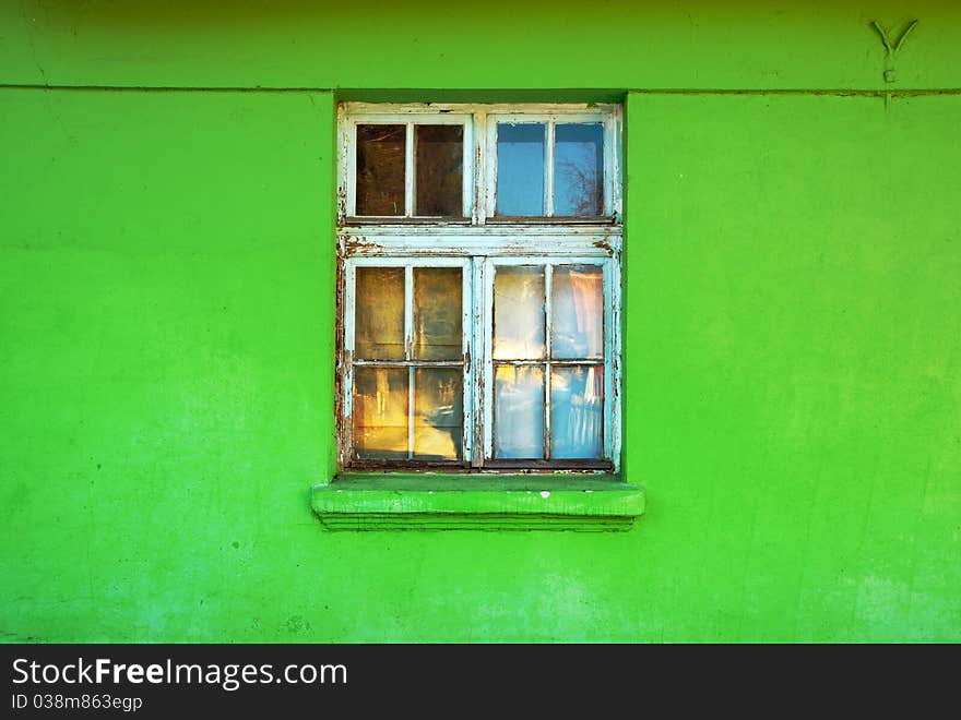 Old window of an old green house.