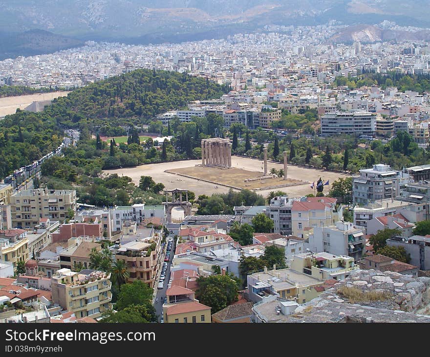 A view of Athen's houses with the remaining pillars of the big Zeus' temple in the centre of it seen from the acropolis. A view of Athen's houses with the remaining pillars of the big Zeus' temple in the centre of it seen from the acropolis