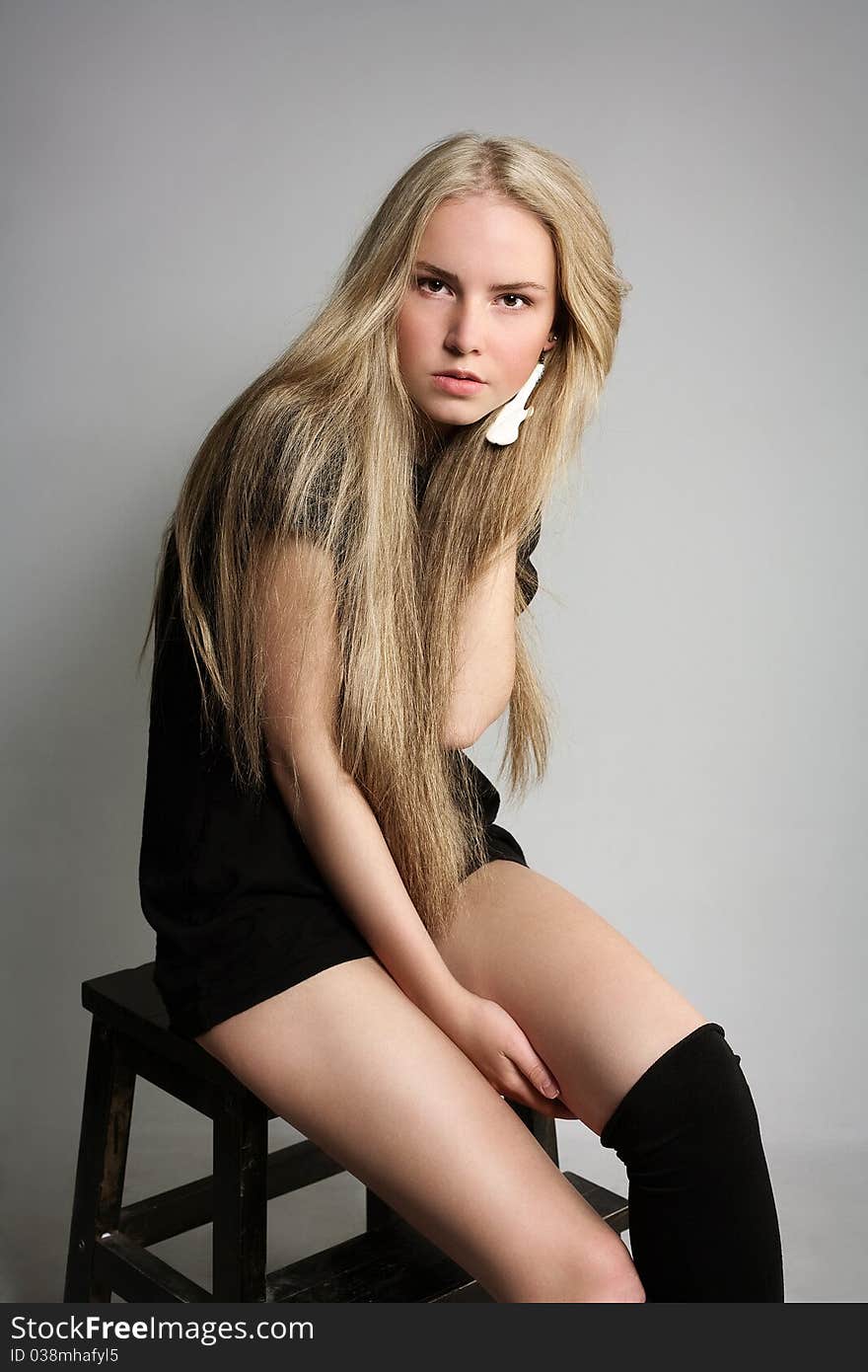 Portrait of attractive beautiful young girl posing on grey background. Portrait of attractive beautiful young girl posing on grey background