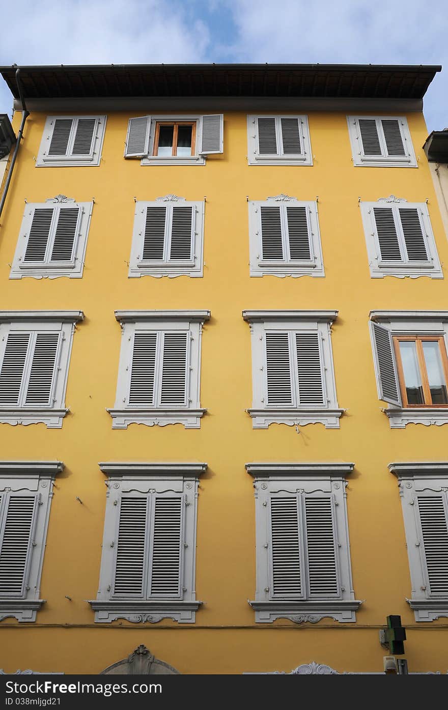 Shuttered windows on an old yellow building in Florence Italy