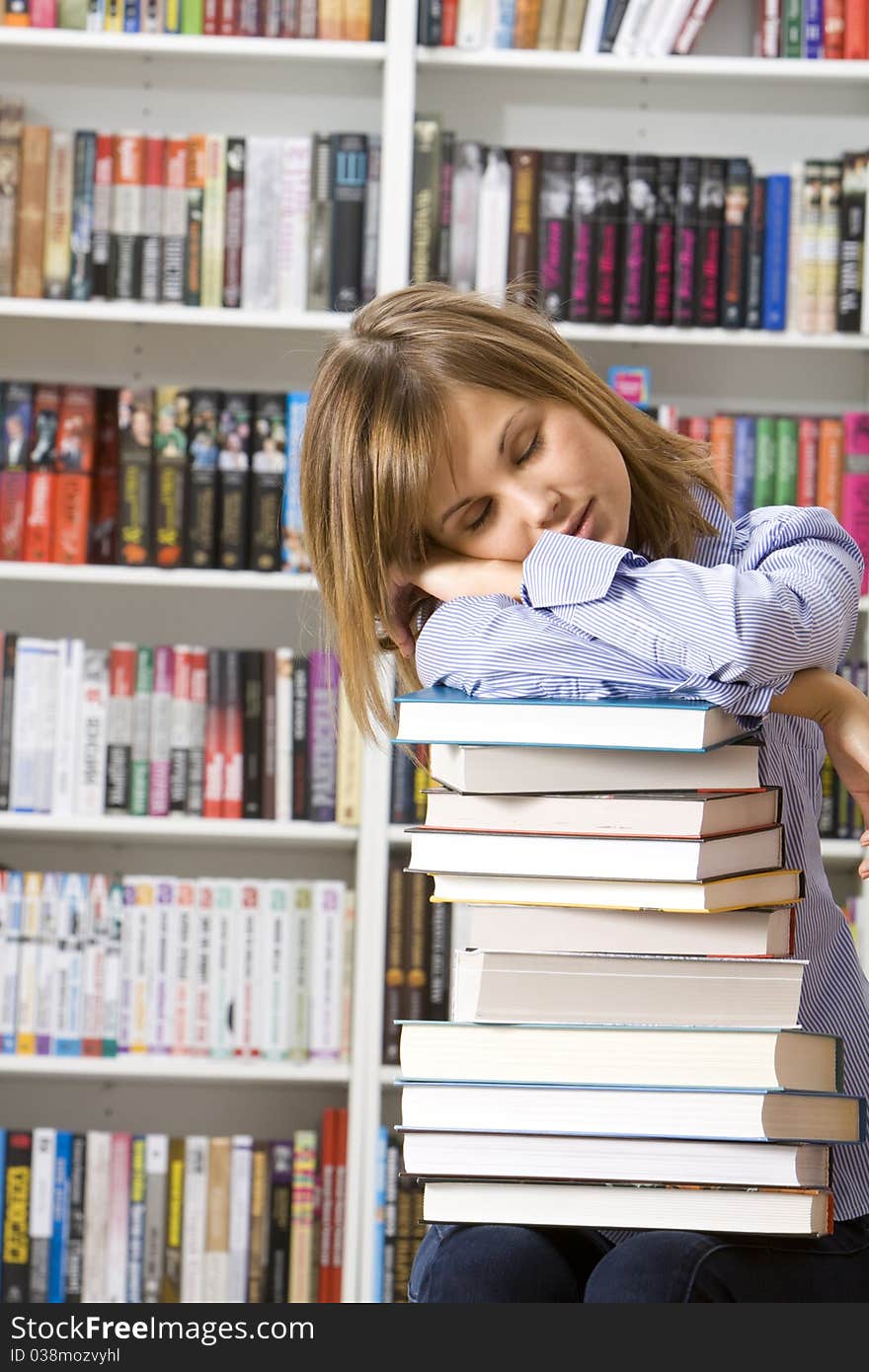 Young woman sleeping with books