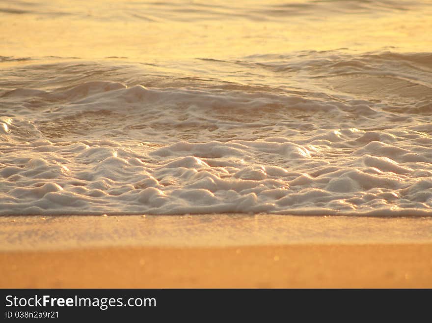 Gentle Foamng Waves Lapping at the Shoreline - Stockon Beach Australia. Gentle Foamng Waves Lapping at the Shoreline - Stockon Beach Australia