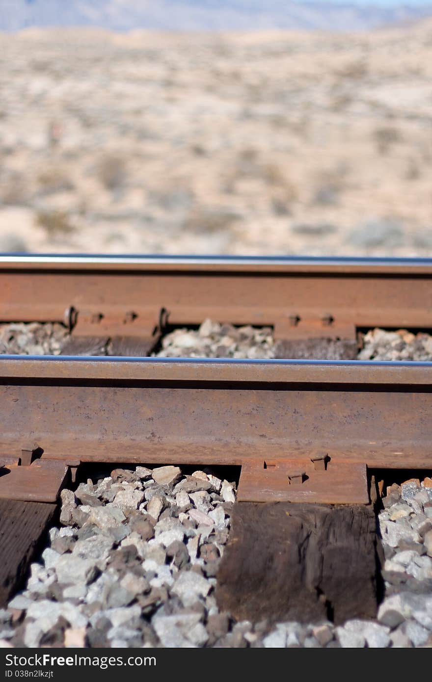 A photograph focused on the railroad metal track. A photograph focused on the railroad metal track.