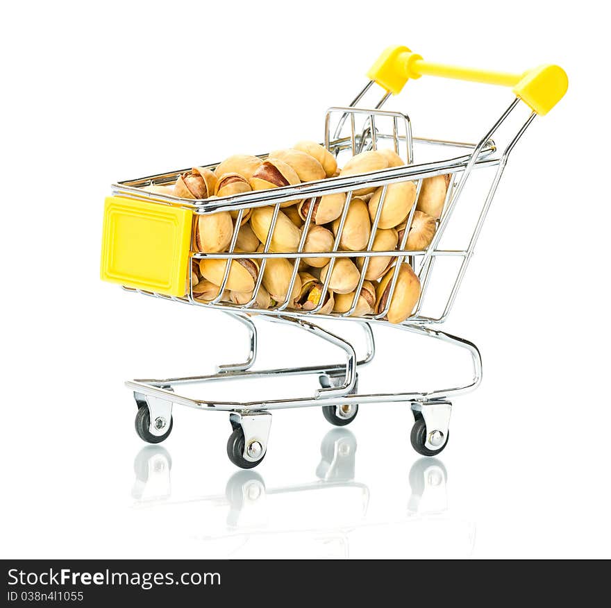 Pistachios in the shopping cart. Isolated.