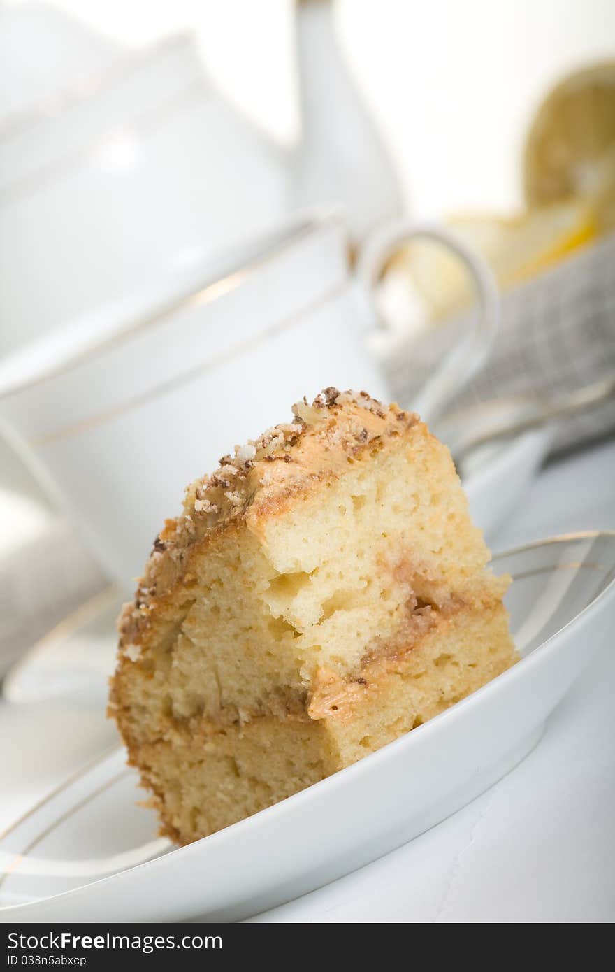 Delicious homemade cake on a plate and a mug full of tea. Delicious homemade cake on a plate and a mug full of tea