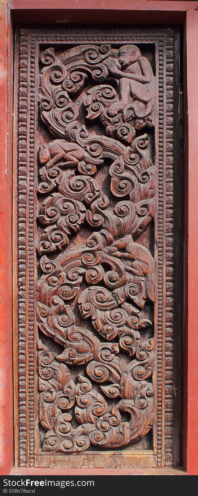 Decorated wooden beside door in Buddhist temple, Laos