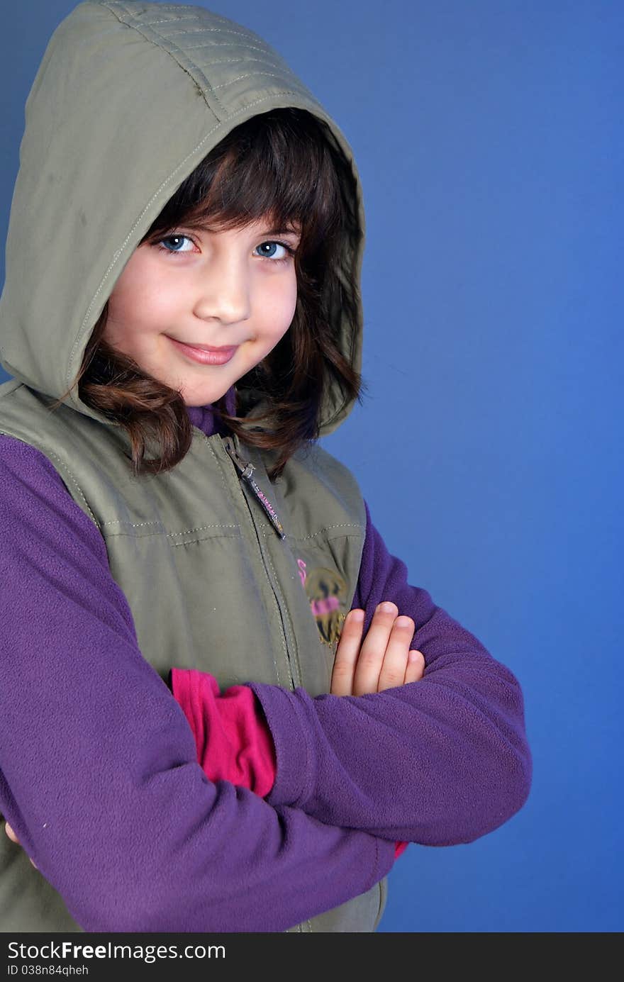 Little girl posing on blue background