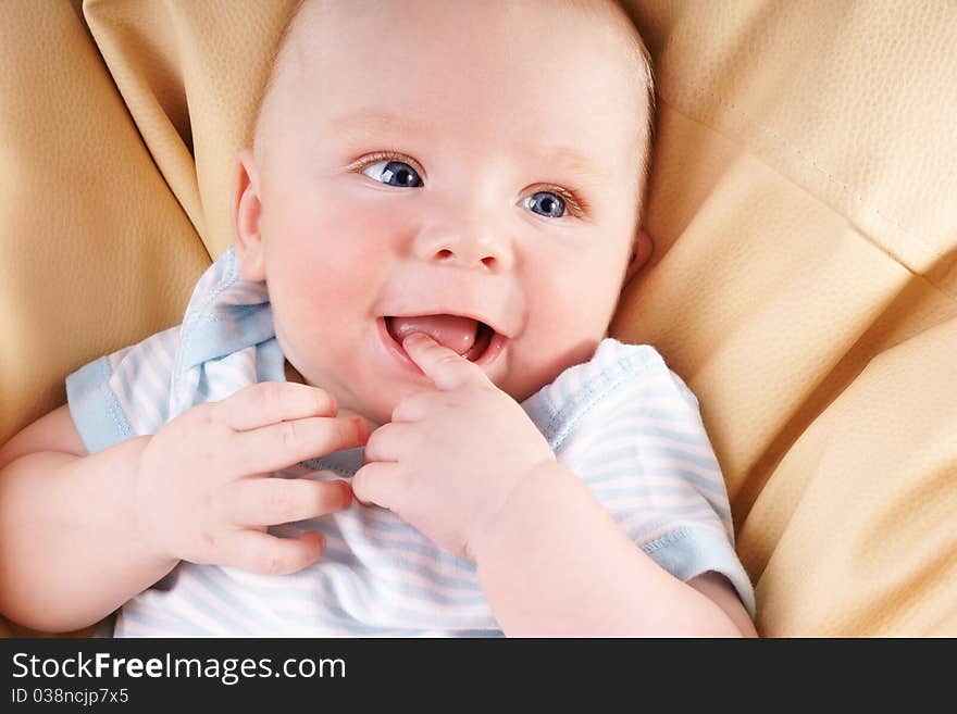 Portrait of cute happy blue-eyed laughing baby-boy, studio shot. Portrait of cute happy blue-eyed laughing baby-boy, studio shot