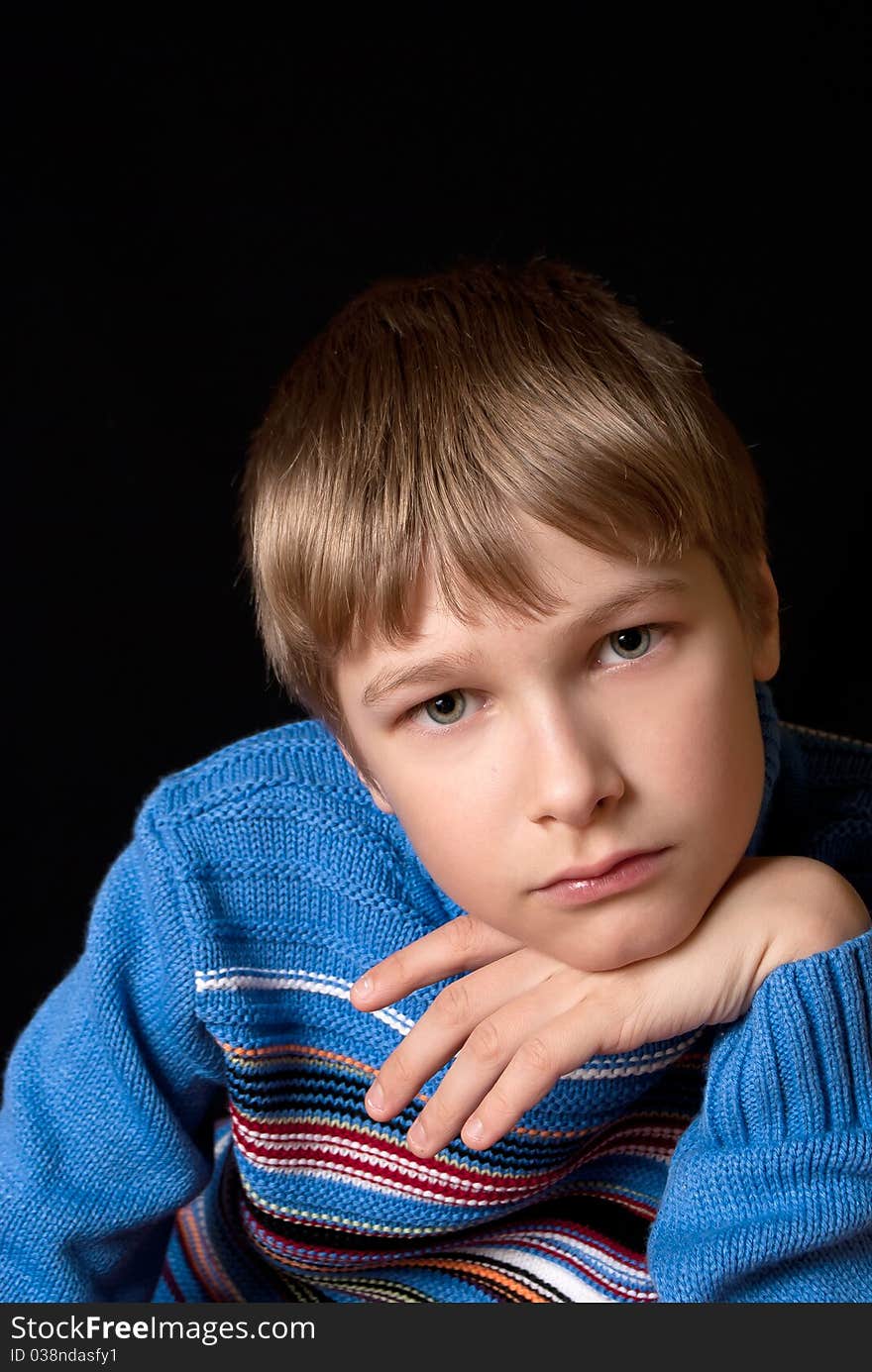 Portrait of a teenager on a black background. background. Happy youth.