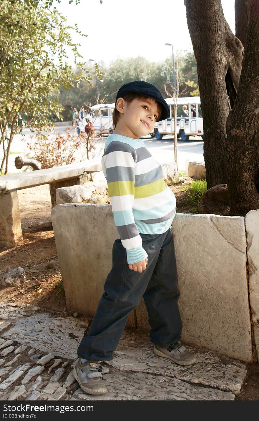 Full-length portrait of stylish smiling little boy, outdoor shot. Full-length portrait of stylish smiling little boy, outdoor shot