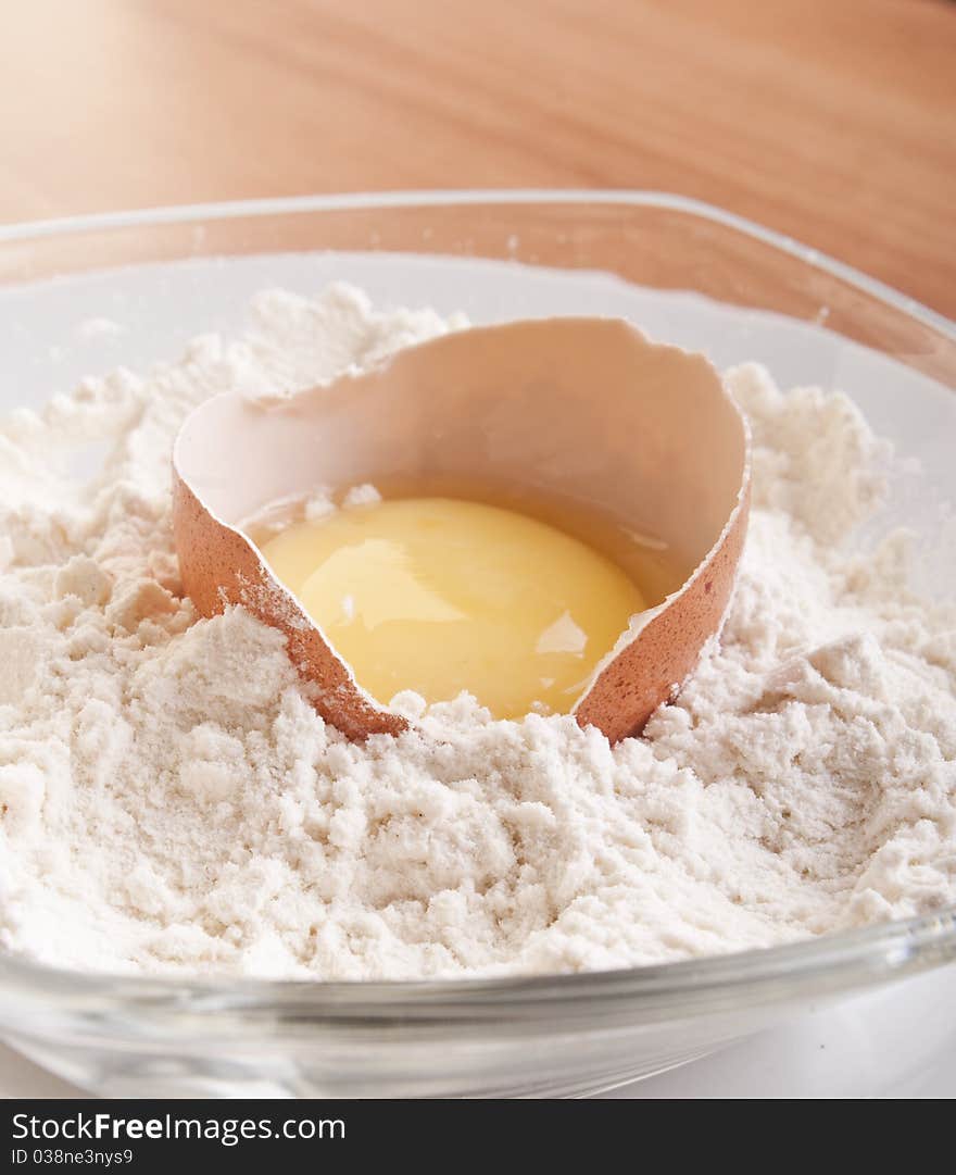 Broken egg with shell on flour