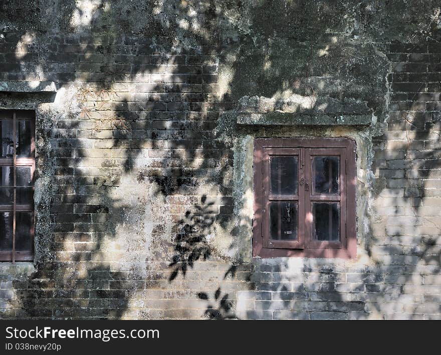 Wooden windows attached on aged wall in sun shine shadow. Wooden windows attached on aged wall in sun shine shadow.